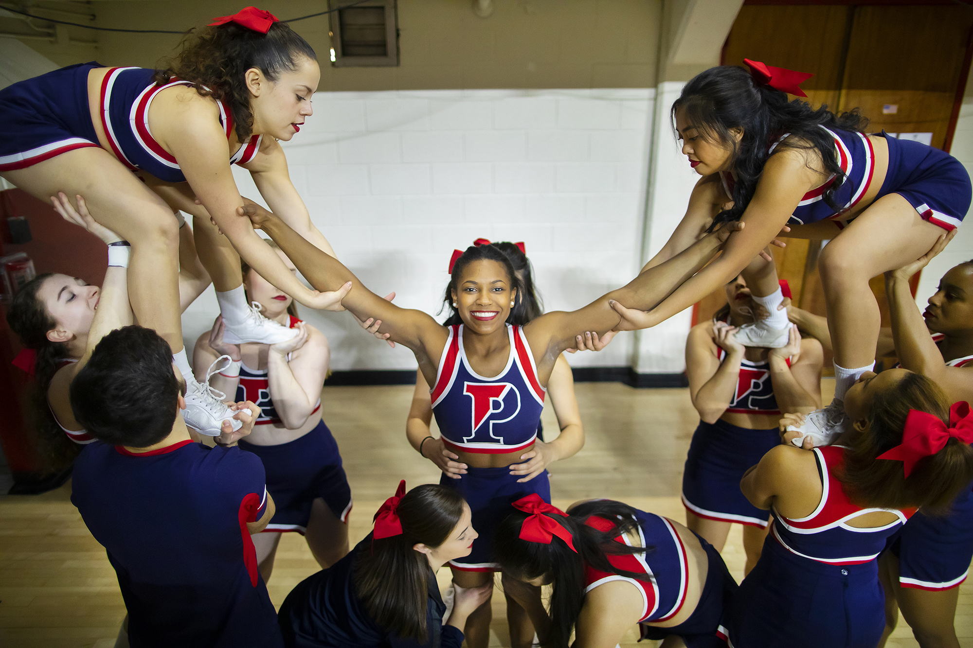 Maya Moore is lifted up by Penn cheerleaders for a cheer at a Penn basketball game.