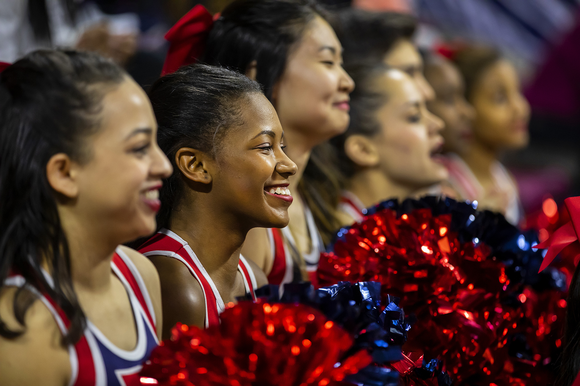 Maya Moore and cheerleaders cheer on Penn at a basketball game.