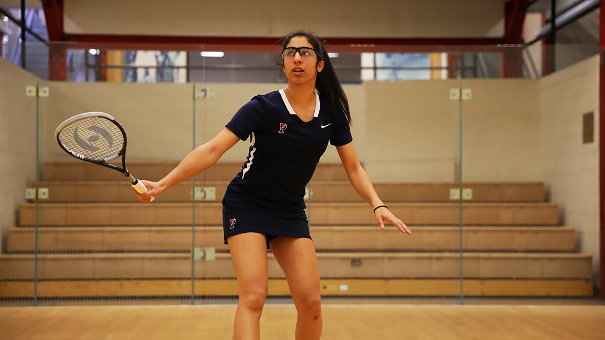 Reeham Sedky prepares to the hit the ball during a squash match.