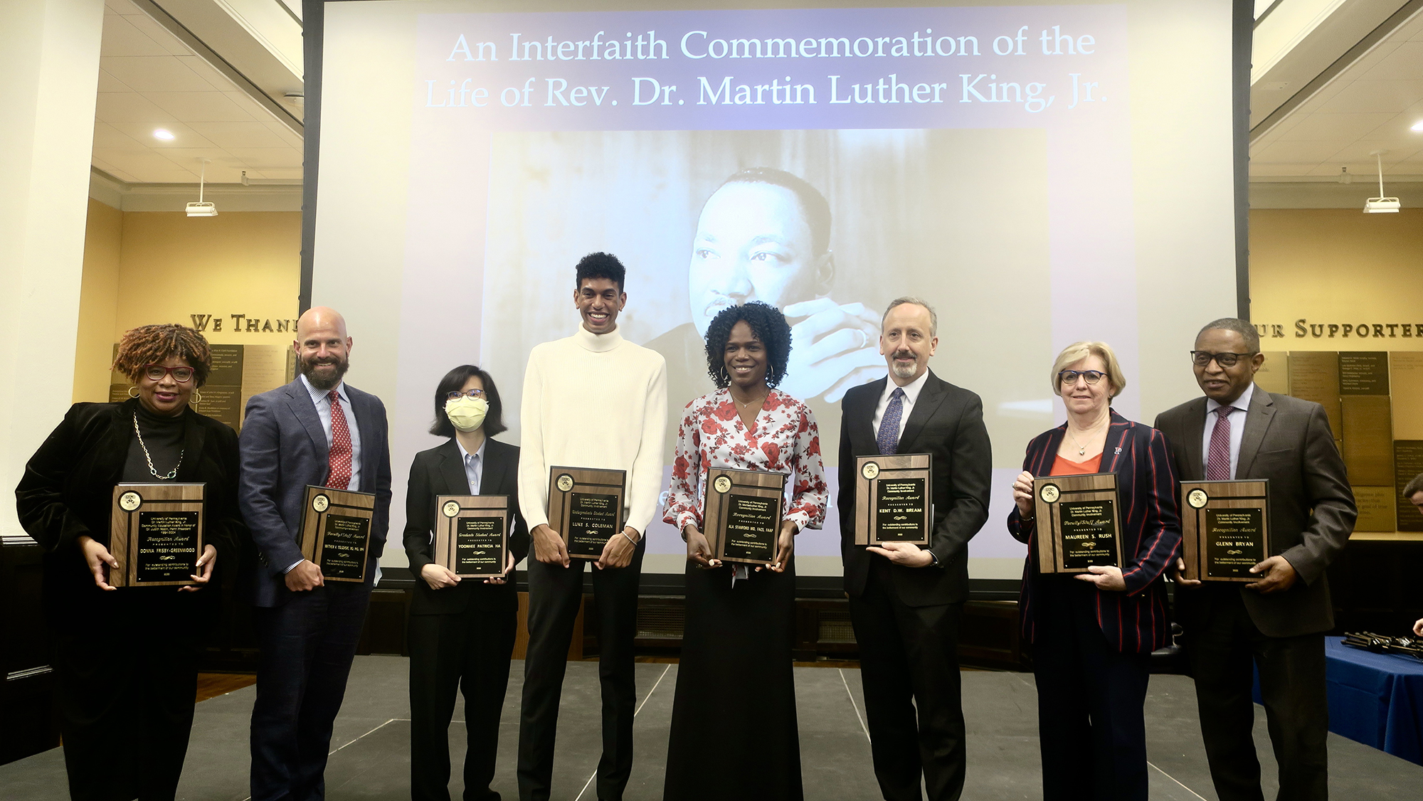 From left to right: Donna Frisby-Greenwood, Matthew Goldshore, Yoonhee Patricia Ha, Luke Coleman, Ala Stanford, Kent D.W. Bream, Maureen Rush, and Glenn D. Bryan stand on stage holding their award plaques.