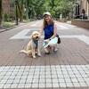 Liz Magill with goldendoodle dog on Locust Walk