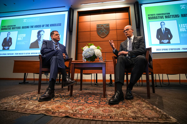 NBC's Lester Holt and colleague Dan Slepian sit in charis on a stage at Penn Carey Law.