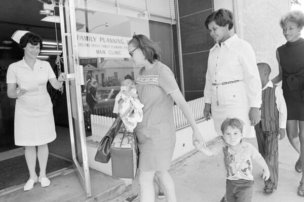 Families walking into a family planning clinic in Louisiana in the 1970s.
