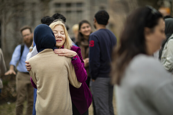 Dr. Amy Gutmann hugs an attendee of the vigil 