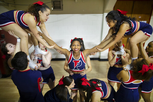 Cheerleaders prepare to lift up Maya Moore during a Penn basketball game.