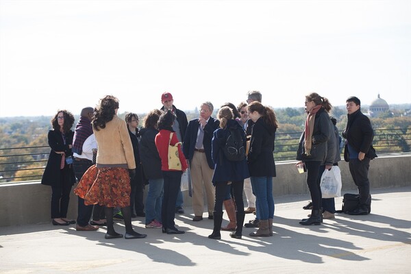 History of Art Professor David Brownlee with tour group atop concrete roof
