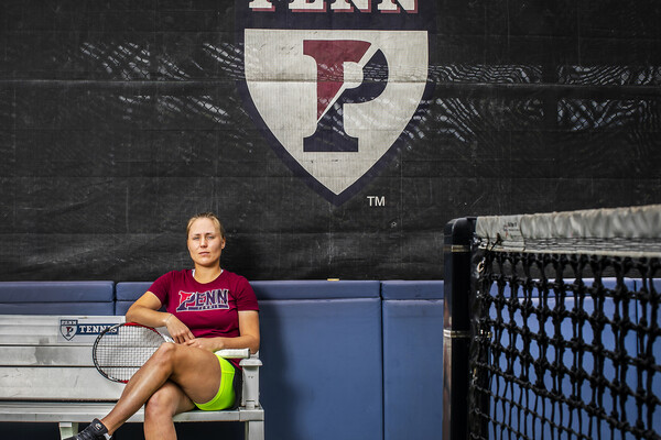 Iuliia Bryzgalova poses on a bench with her racket at the tennis courts at Penn Park.
