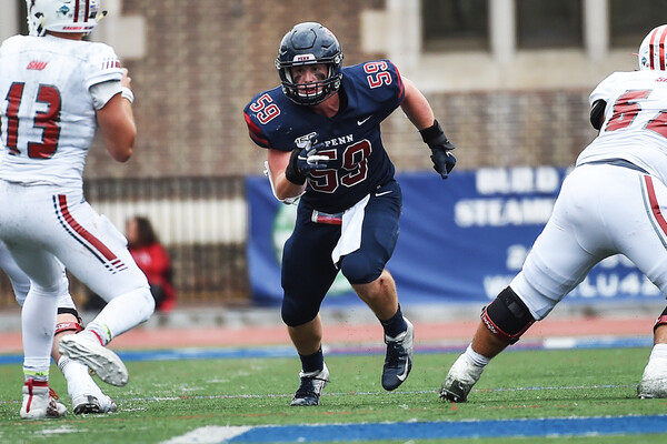 Playing at Franklin Field against Sacred Heart, Brian O’Neill rushes the quarterback.