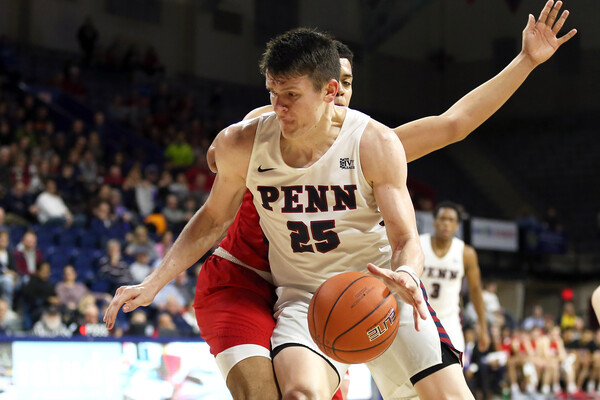 AJ Brodeur of the men's basketball team makes a move with the ball during a game at the Palestra.