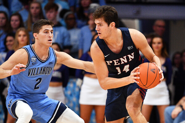 Max Martz of the men's basketball makes a move with the ball while being guarded by a defender during an away game at Villanova.