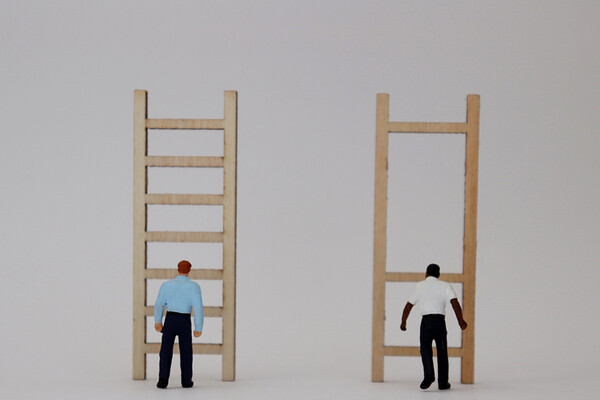 white man in front of ladder next to Black man in front of ladder missing rungs