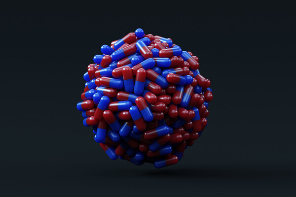 Ball of red and blue prescription drug capsules.