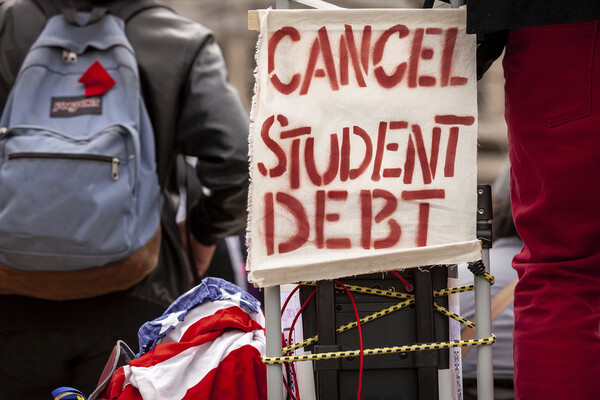 A sign calls for the cancellation of student debt at a rally