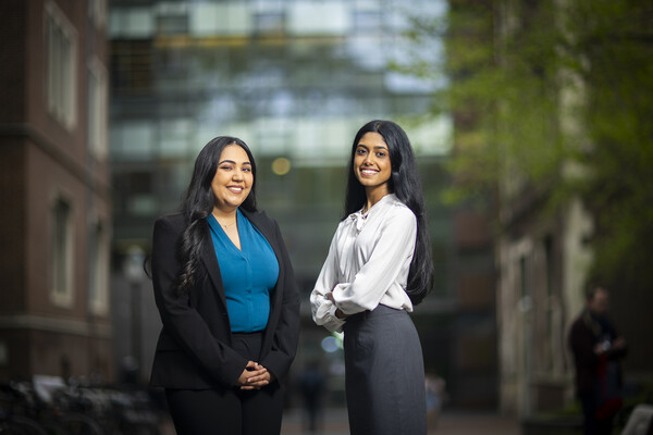 Penn fourth-years Simran Rajpal on the left and Gauthami Moorkanatst on the right pose outside Fisher-Bennett Hall on Penn campus.