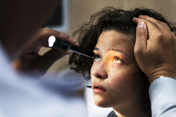A teenager having their eyesight examined.